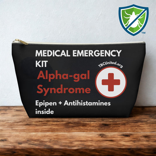 Black medical emergency kit labeled 'Alpha-gal Syndrome' with a red cross on a wooden surface.