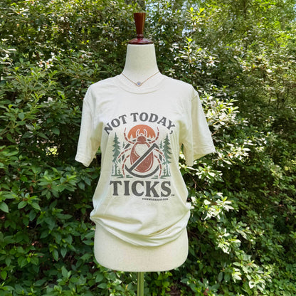 White t-shirt with 'Not Today Ticks' graphic on a mannequin against a forest background